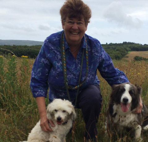 Karen in a field with her two dogs